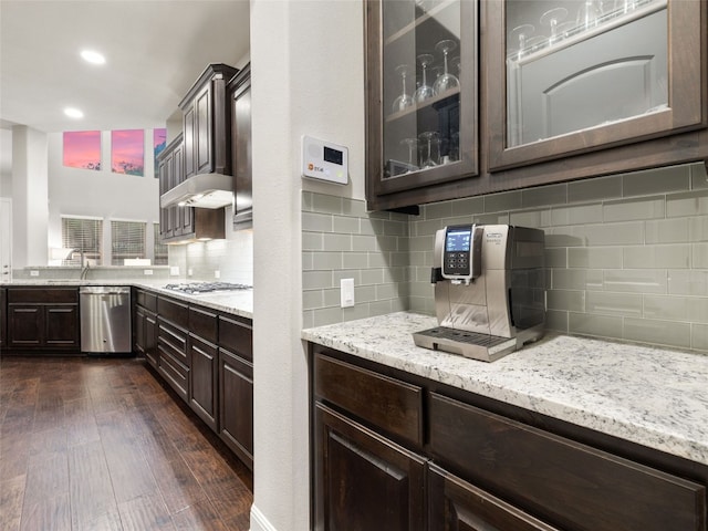 3417 Flat Iron Ct, Leander, TX 78641 - kitchen featuring stainless steel dishwasher, dark brown cabinetry, ventilation hood, glass insert cabinets, and recessed lighting