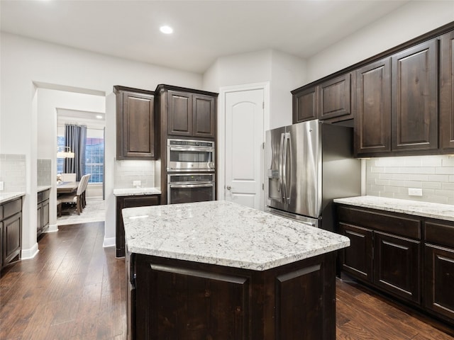 3417 Flat Iron Ct, Leander, TX 78641 - kitchen featuring appliances with stainless steel finishes, tasteful backsplash, dark brown cabinets, and recessed lighting