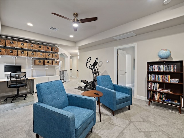 living area with arched walkways, recessed lighting, visible vents, and light colored carpet