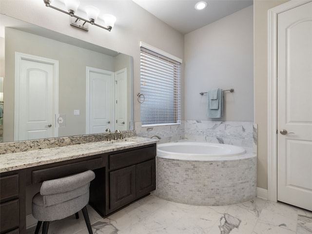 full bathroom featuring a closet, marble finish floor, vanity, and a bath