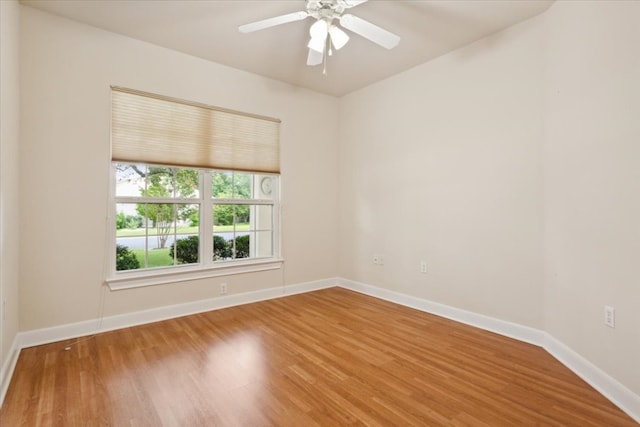 spare room with hardwood / wood-style flooring and ceiling fan