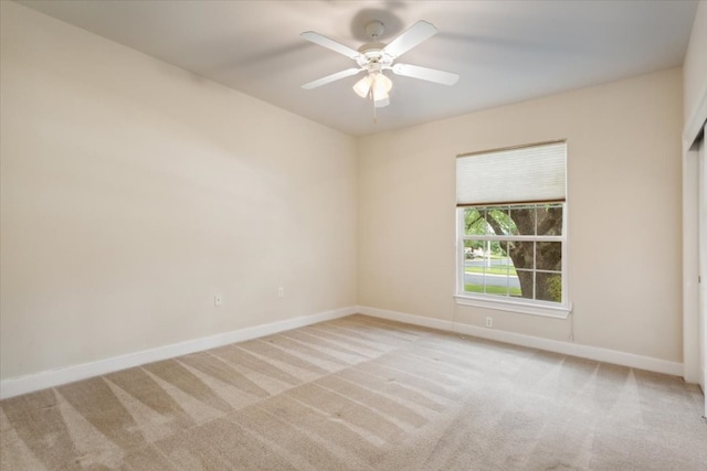 unfurnished room with ceiling fan and light colored carpet