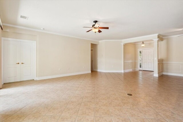 spare room with crown molding, ceiling fan, and light tile patterned floors