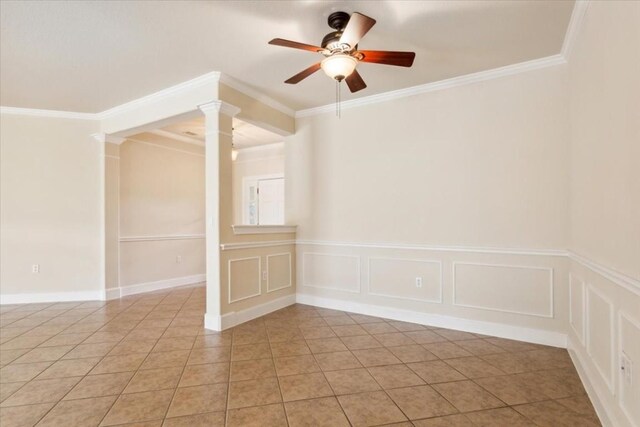 tiled spare room featuring crown molding, ceiling fan, and ornate columns