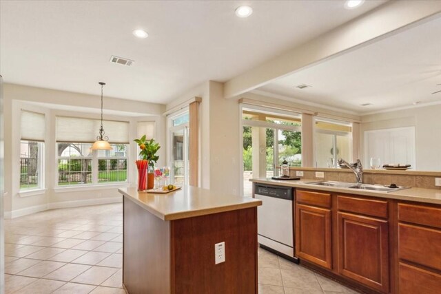 kitchen with light tile patterned floors, white dishwasher, a kitchen island, pendant lighting, and sink