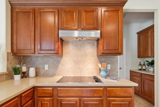 kitchen featuring black electric cooktop, tasteful backsplash, and light tile patterned floors