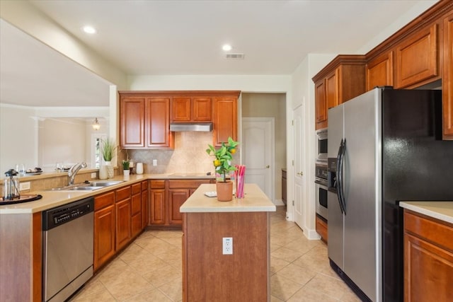 kitchen with sink, a center island, appliances with stainless steel finishes, and light tile patterned floors