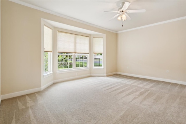 unfurnished room featuring ornamental molding, carpet floors, and ceiling fan