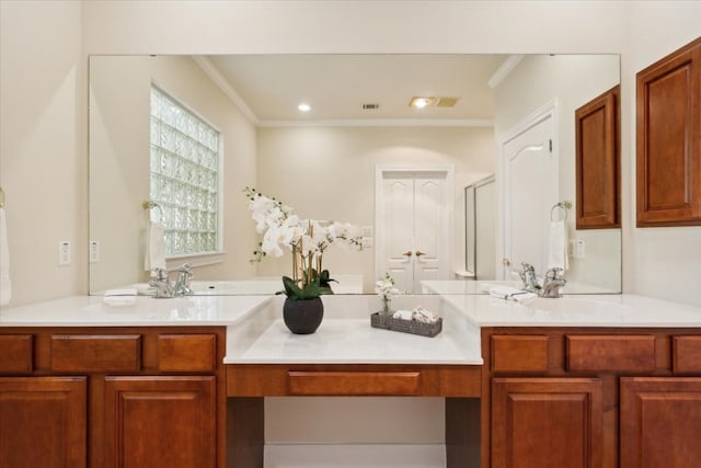 bathroom with ornamental molding and dual vanity