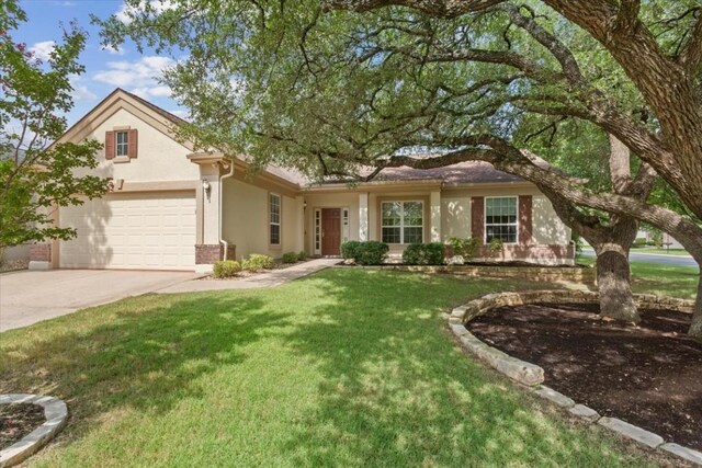 ranch-style home with a garage and a front lawn