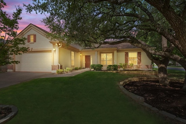 view of front facade with a garage and a yard