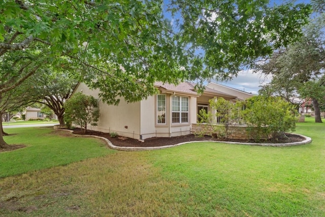 view of side of property with a yard