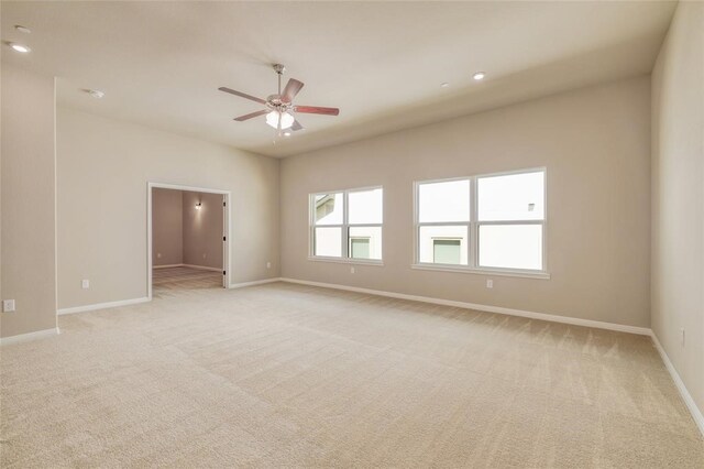 empty room featuring light colored carpet and ceiling fan