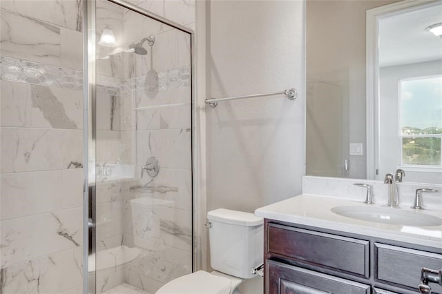 bathroom with toilet, vanity, and an enclosed shower