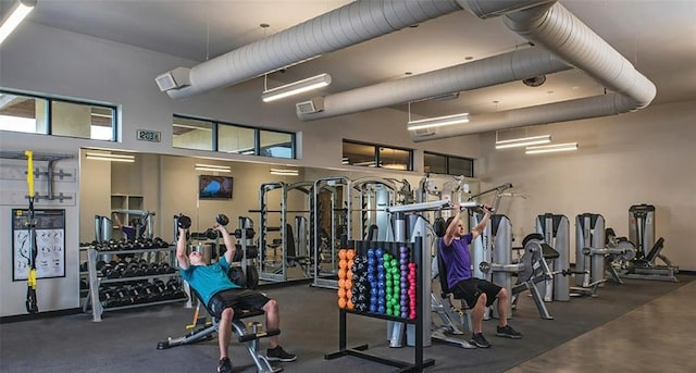 gym with a towering ceiling