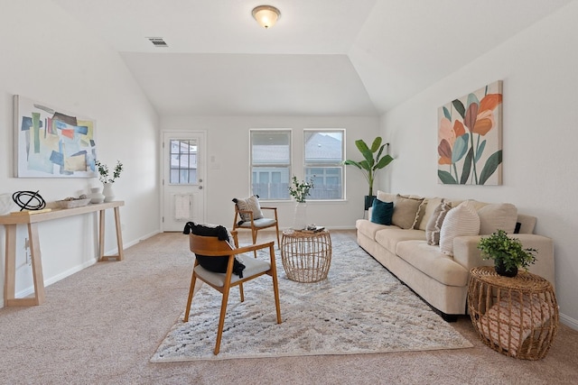 carpeted living room featuring vaulted ceiling