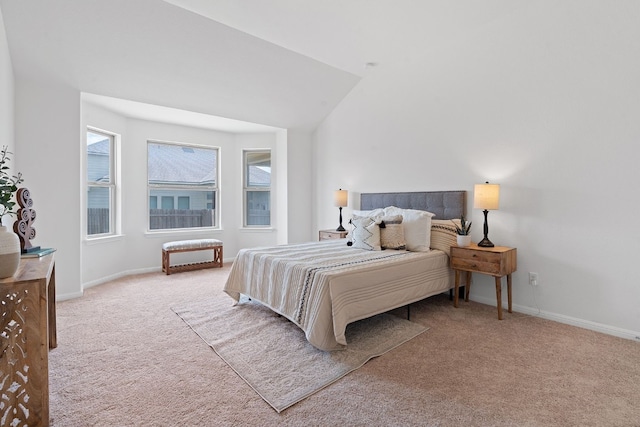 carpeted bedroom with lofted ceiling