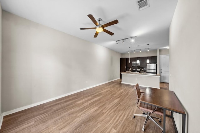 1900 Barton Springs Rd Unit 2046, Austin, TX 78704 - unfurnished living room featuring rail lighting, ceiling fan, and light wood finished floors