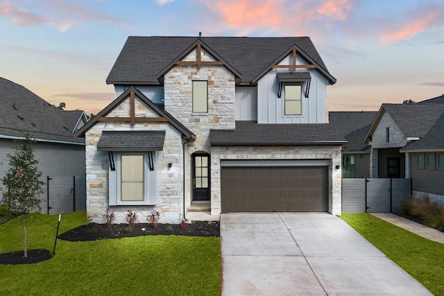 view of front of property featuring a lawn and a garage