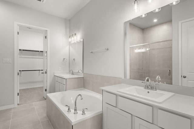 bathroom featuring tile patterned floors, vanity, and plus walk in shower