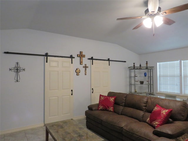 living room featuring a barn door, lofted ceiling, and ceiling fan