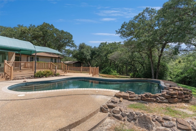 view of swimming pool with a wooden deck