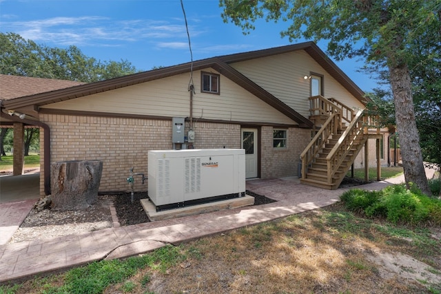 back of house featuring central AC unit