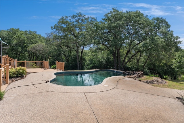 view of swimming pool with a patio area