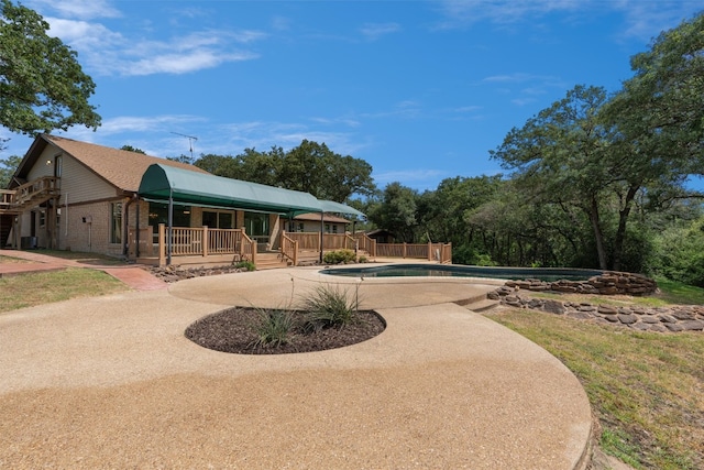 exterior space featuring a swimming pool side deck