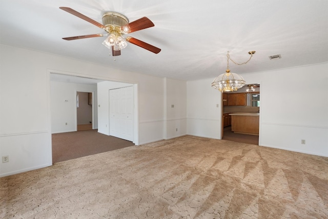 empty room featuring carpet flooring and ceiling fan