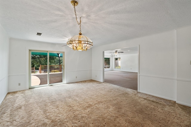 carpeted empty room with a textured ceiling and ceiling fan with notable chandelier