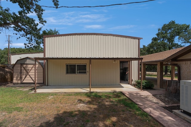 back of house with an outbuilding