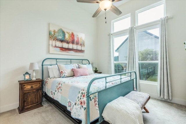 bedroom with ceiling fan and light colored carpet