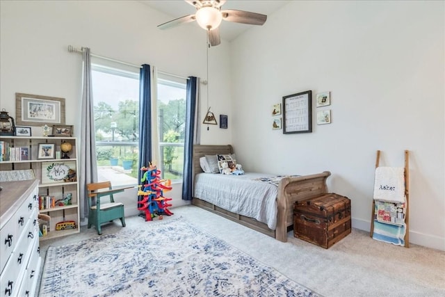 bedroom with ceiling fan and light colored carpet