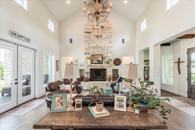 living room with hardwood / wood-style floors, high vaulted ceiling, and plenty of natural light