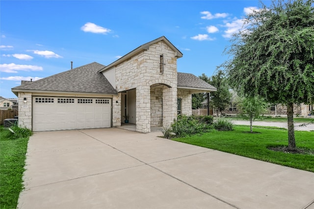 view of front of home with a garage and a front lawn