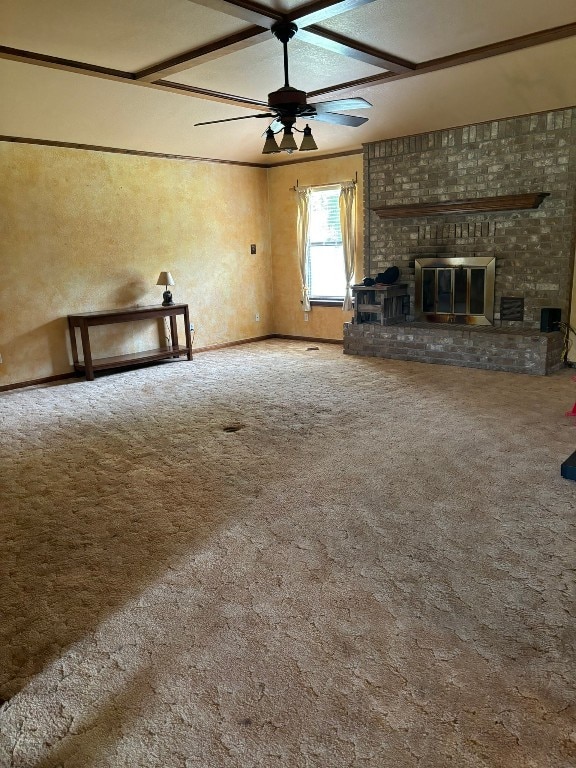 unfurnished living room featuring a fireplace, carpet flooring, coffered ceiling, and ceiling fan