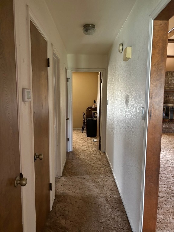 hallway with light colored carpet