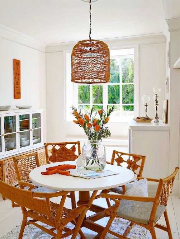 dining space featuring tile patterned flooring, a notable chandelier, and ornamental molding