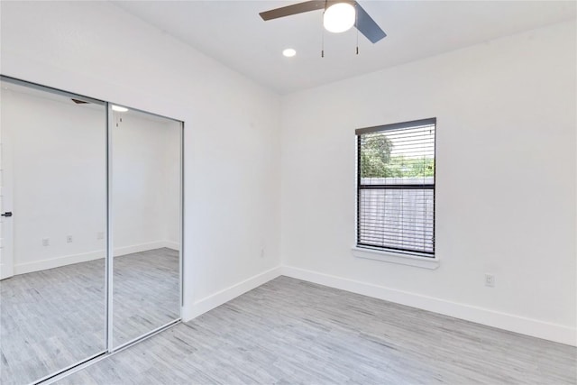 314 Saxon Ln, Austin, TX 78741 - unfurnished bedroom with light wood-style floors, a closet, and a ceiling fan