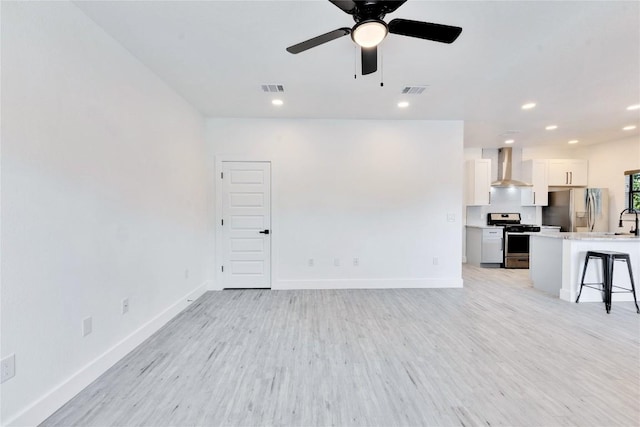 314 Saxon Ln, Austin, TX 78741 - unfurnished living room with recessed lighting, light wood-style floors, and a ceiling fan