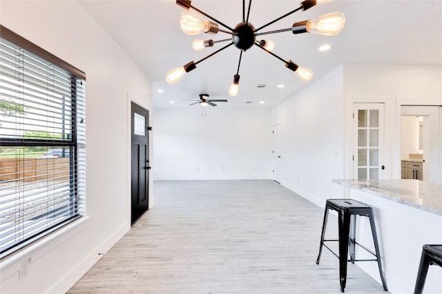 314 Saxon Ln, Austin, TX 78741 - unfurnished living room featuring light wood finished floors, recessed lighting, and a chandelier