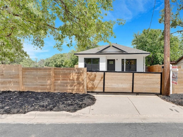 314 Saxon Ln, Austin, TX 78741 - view of front facade with a fenced front yard and roof with shingles