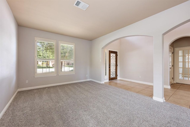 spare room with light colored carpet