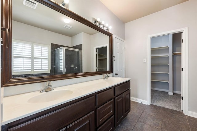 bathroom featuring tile patterned floors, vanity, and an enclosed shower