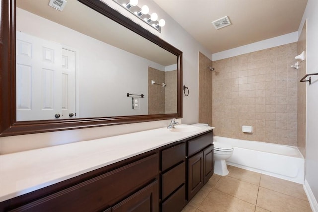 full bathroom featuring vanity, tiled shower / bath combo, tile patterned floors, and toilet