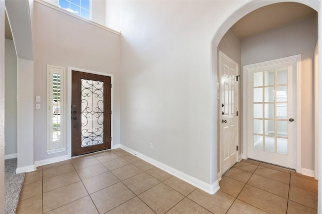 entryway featuring plenty of natural light and light tile patterned floors