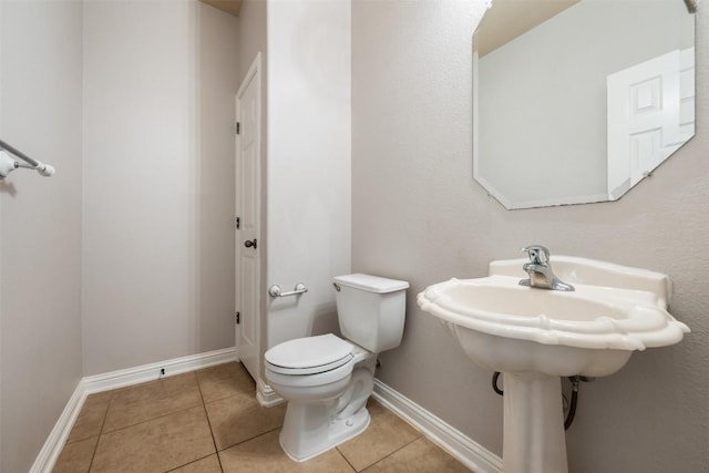 bathroom with tile patterned flooring and toilet