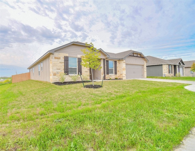 ranch-style house featuring a front yard and a garage