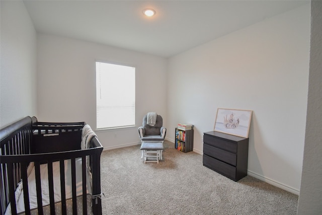 carpeted bedroom with a crib